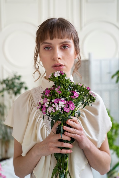 Porträt einer jungen Frau mit Blumen, die ein Boho-Chic-Kleid tragen