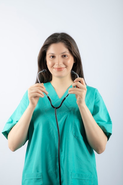 Porträt einer jungen Ärztin mit Stethoskop in Uniform.
