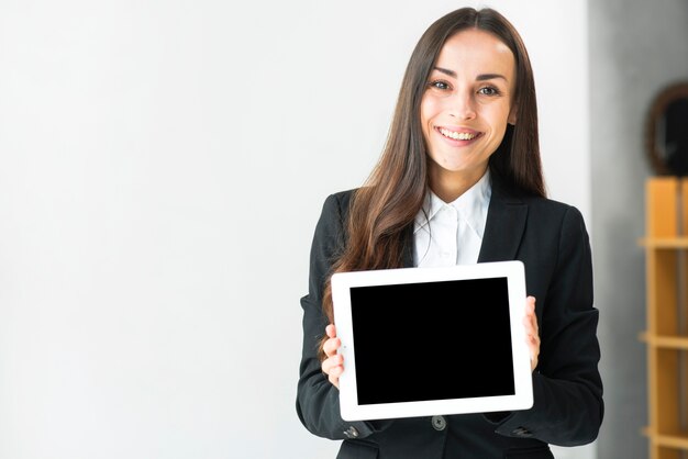 Porträt einer lächelnden jungen Geschäftsfrau, die digitale Tablette des Touch Screen zeigt