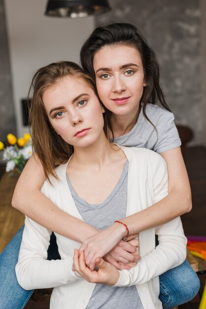 Porträt eines jungen romantischen lesbischen Paares, das Kamera betrachtet