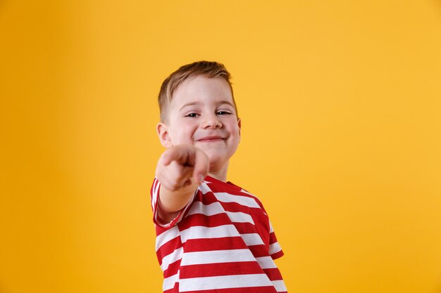 Porträt eines lächelnden kleinen Jungen, der Finger zeigt