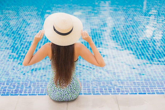 Kostenloses Foto porträt schöne junge asiatische frau im freien im schwimmbad in urlaubsreise entspannen