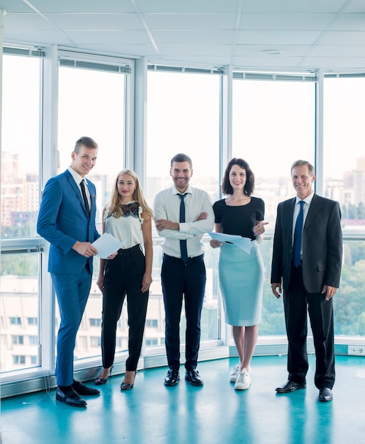 Kostenloses Foto porträt von den überzeugten wirtschaftlern, die im büro stehen