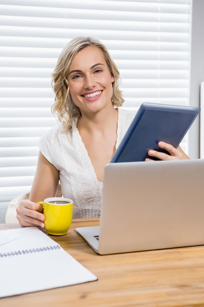 Portrait der schönen Frau, die digitale Tablet und Kaffeetasse