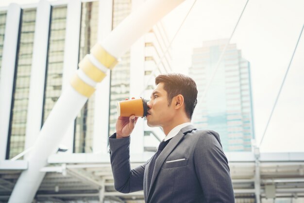 Portrait eines selbstbewussten Geschäftsmannes trinken Kaffee im Freien