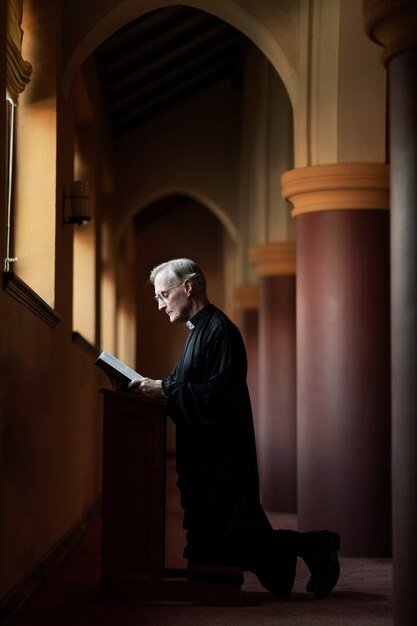 Priester, der in der Kirche betet