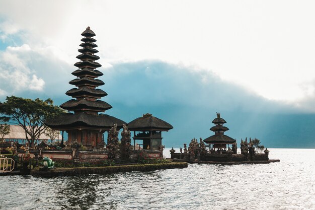 Pura Ulun Danu Bratan, Bali. Hinduistischer Tempel, umgeben von Blumen am Bratan See