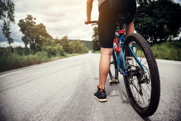 Radfahrer-Mann, der das Fahrrad im Freien läuft