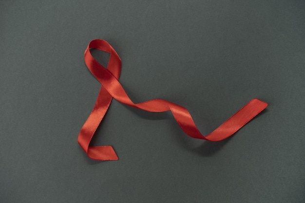 Red ribbon hiv-bewusstseinskonzept welthilfetag und welttag der sexuellen gesundheit.