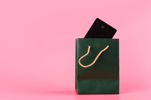 Reisende Karte innerhalb der grünen Einkaufstasche gegen rosa Hintergrund
