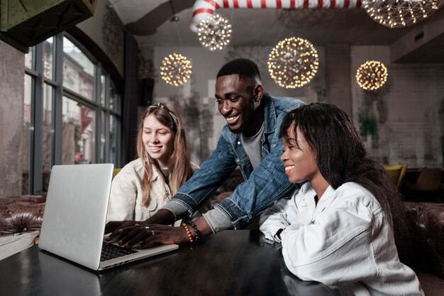 Reizende Freunde, die zuhause Laptop betrachten