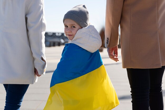 Rückansicht kleines kind mit ukrainischer flagge