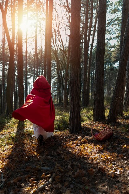 Rückansicht Rotkäppchen im Wald