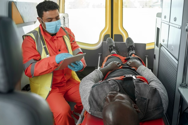 Kostenloses Foto sanitäter im hohen winkel, der eine tablette hält