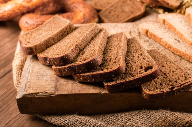 Scheiben von dunklem und weißem Brot auf dem Küchenbrett