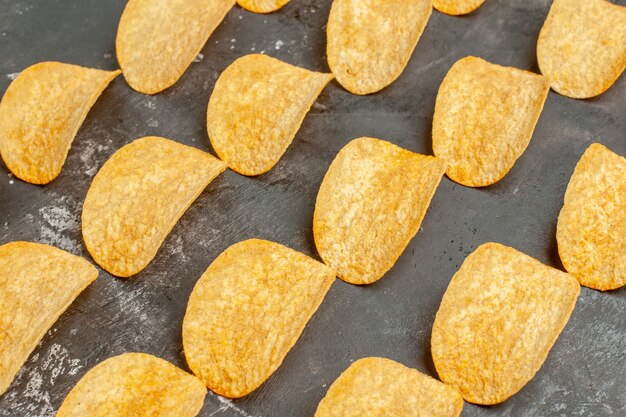 Schließen Sie herauf Ansicht der Snack-Party für Freunde mit leckeren Kartoffelchips auf grauem Tisch