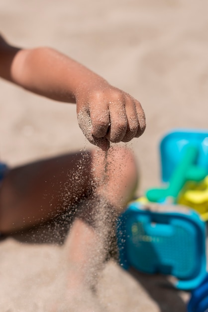 Schließen Sie oben vom strömenden Sand des Kindes