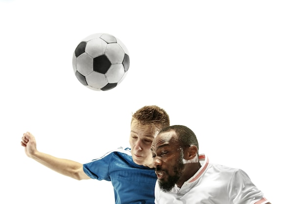 Schließen Sie oben von den emotionalen Männern, die Fußball spielen, die den Ball mit dem Kopf auf lokalisiert auf weißer Wand schlagen. Fußball, Sport, Gesichtsausdruck, menschliches Gefühlskonzept. Copyspace. Kämpfe um das Ziel.