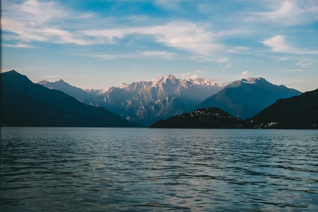 Schöne Aufnahme eines Meeres und des Rocky Mountain in der Ferne mit Wolken am Himmel