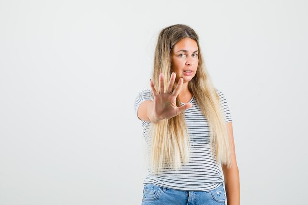 Kostenloses Foto schöne dame, die etwas im t-shirt ablehnt und unzufrieden aussieht, vorderansicht.