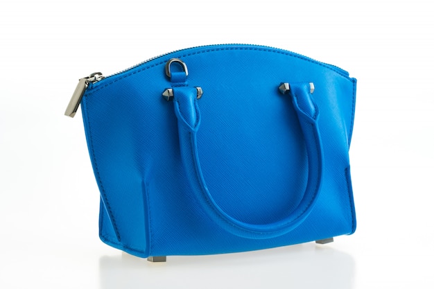 Schöne Eleganz und Luxusmodefrauen und blaue Handtasche