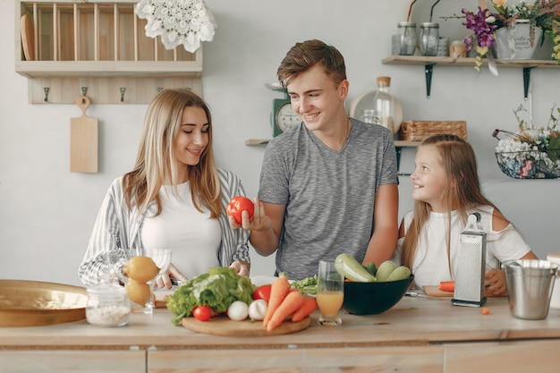 Schöne familie essen in einer küche zubereiten