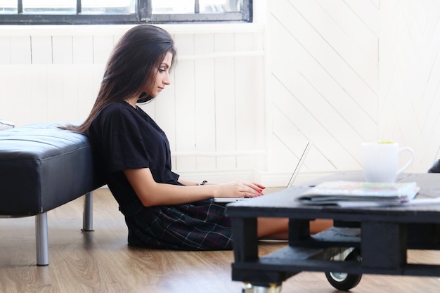 Schöne Frau, die an ihrem Laptop arbeitet