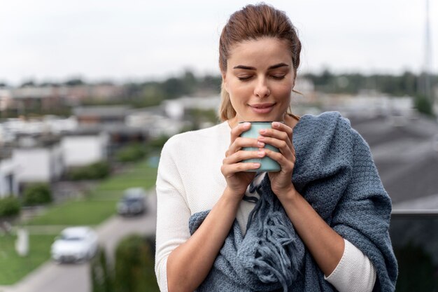 Schöne Frau, die eine Tasse Kaffee genießt