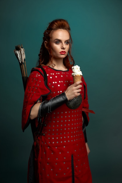 Schöne Frau im mittelalterlichen Kostüm, das Eis hält.