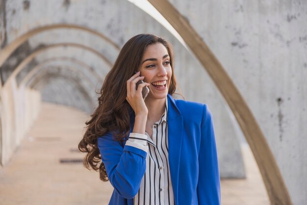 Schöne Frau lachend, während Gespräch am Telefon