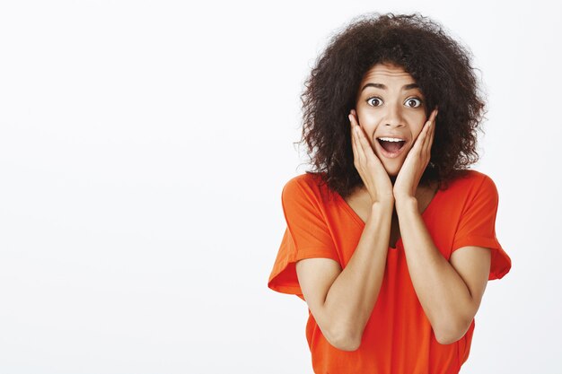 schöne frau mit afro frisur posiert im studio