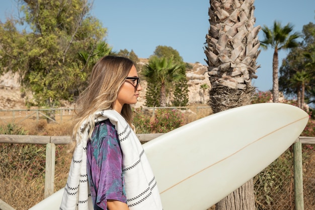 Kostenloses Foto schöne frau mit surfbrett am strand