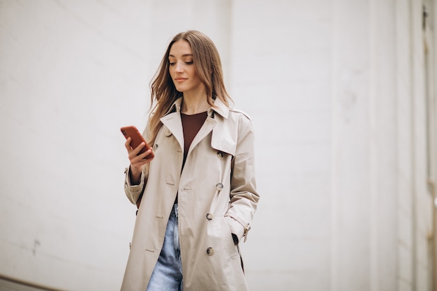 Schöne Frau mit Telefon im Freien