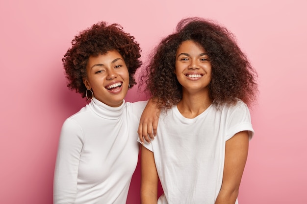 Schöne glückliche dunkelhäutige Frauen haben Spaß zusammen, genießen Freizeit, lächeln glücklich