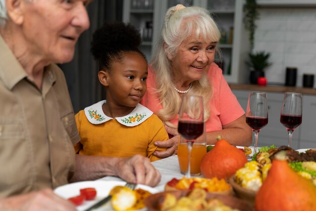 Schöne glückliche Familie, die zusammen ein Thanksgiving-Dinner isst