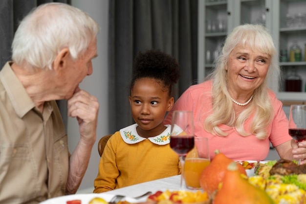 Schöne glückliche Familie, die zusammen ein Thanksgiving-Dinner isst