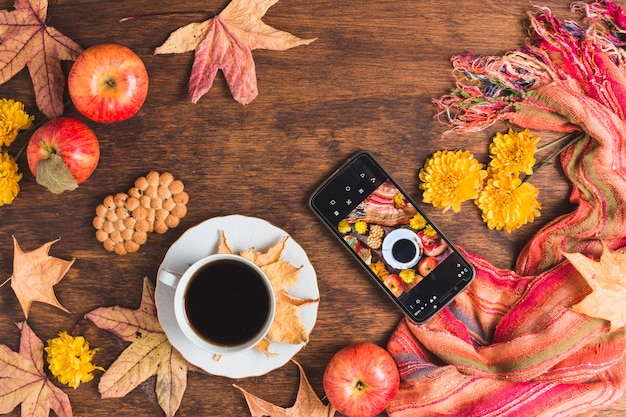Schöne Herbstzusammensetzung mit Kaffee und Smartphone