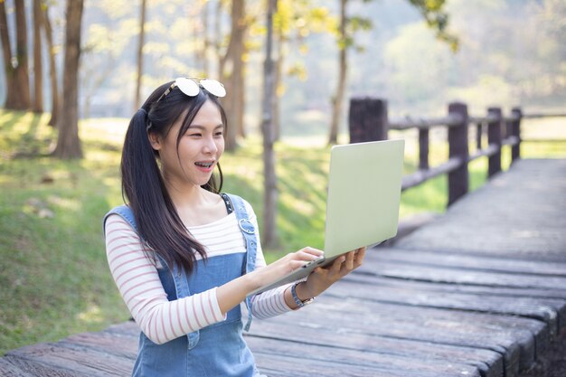 Schöne junge Frau, die Laptop verwendet