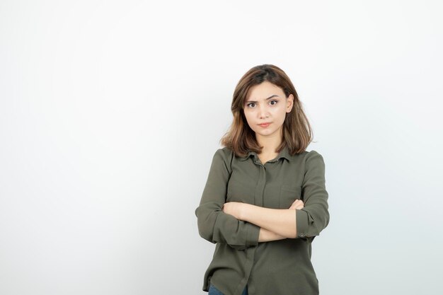 Schöne junge Frau in lässigem Outfit mit verschränkten Armen. Foto in hoher Qualität