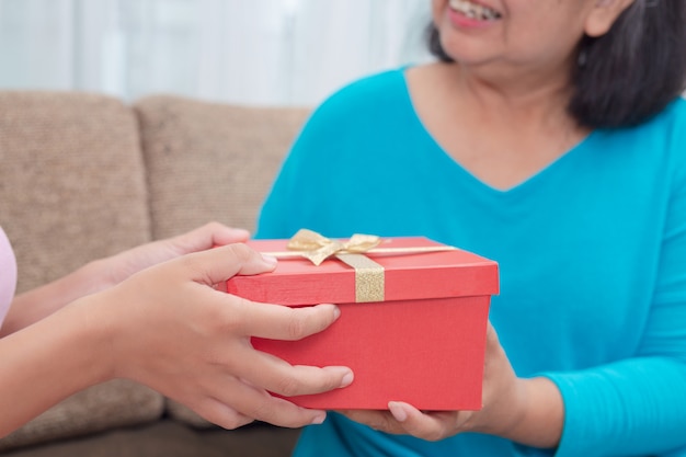 Schöne junge Frauen geben den Müttern Geschenke.