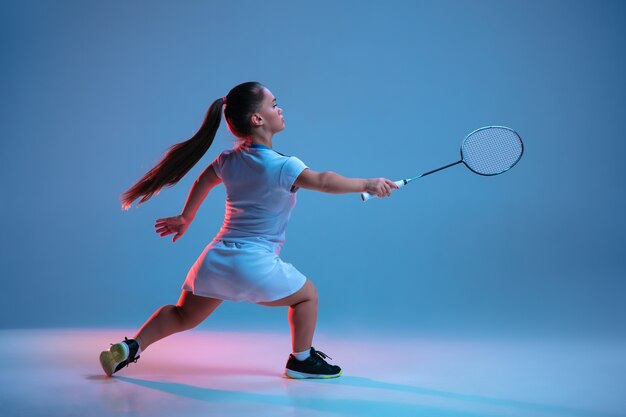 Schöne kleine Frau, die im Badminton übt