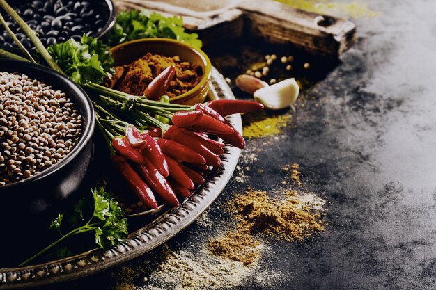 Schöne leckere appetitanregende Zutaten Gewürze Lebensmittel für das Kochen gesunde Küche. Dunkler schwarzer Hintergrund Horizontaler Toning Textfreiraum