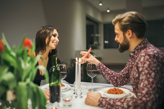 Schöne Paare, die Mahlzeit am Abend genießen