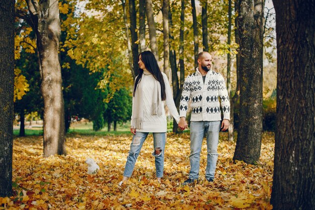 Schöne Paare verbringen Zeit in einem Herbstpark