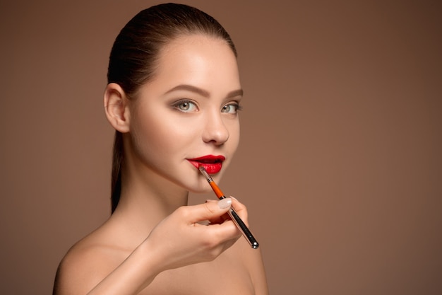 Schöne weibliche Lippen mit Make-up und Pinsel