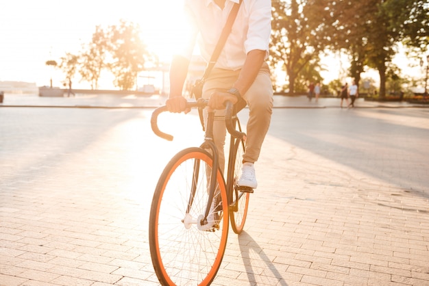 Schöner junger afrikanischer Mann am frühen Morgen mit Fahrrad