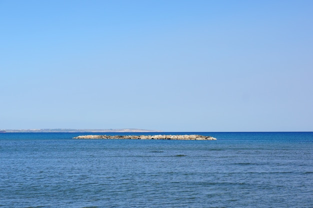 Schöner Schuss einer kleinen Insel bedeckt mit Felsen in der Mitte eines Sees