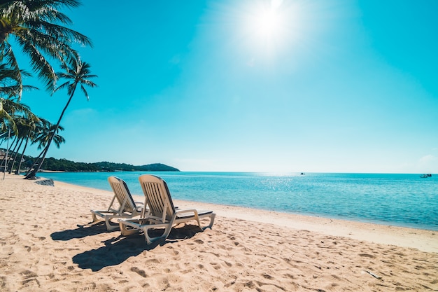 Schöner tropischer Strand und Meer mit Stuhl auf blauem Himmel