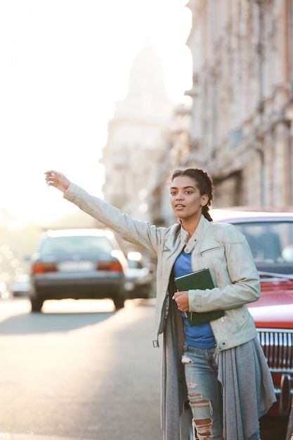 Schönes afrikanisches Mädchen, das das Auto fängt