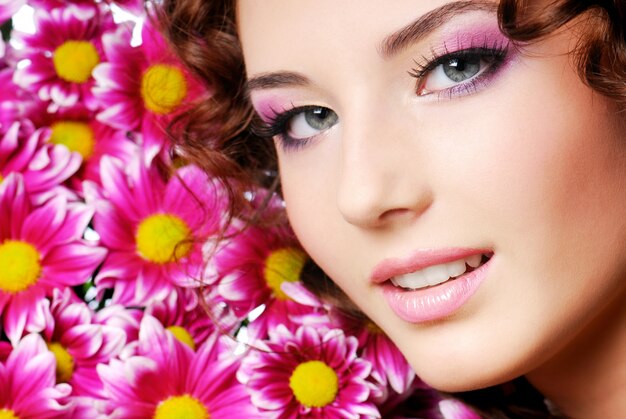 Schönes Mädchenporträt mit rosa Blumen